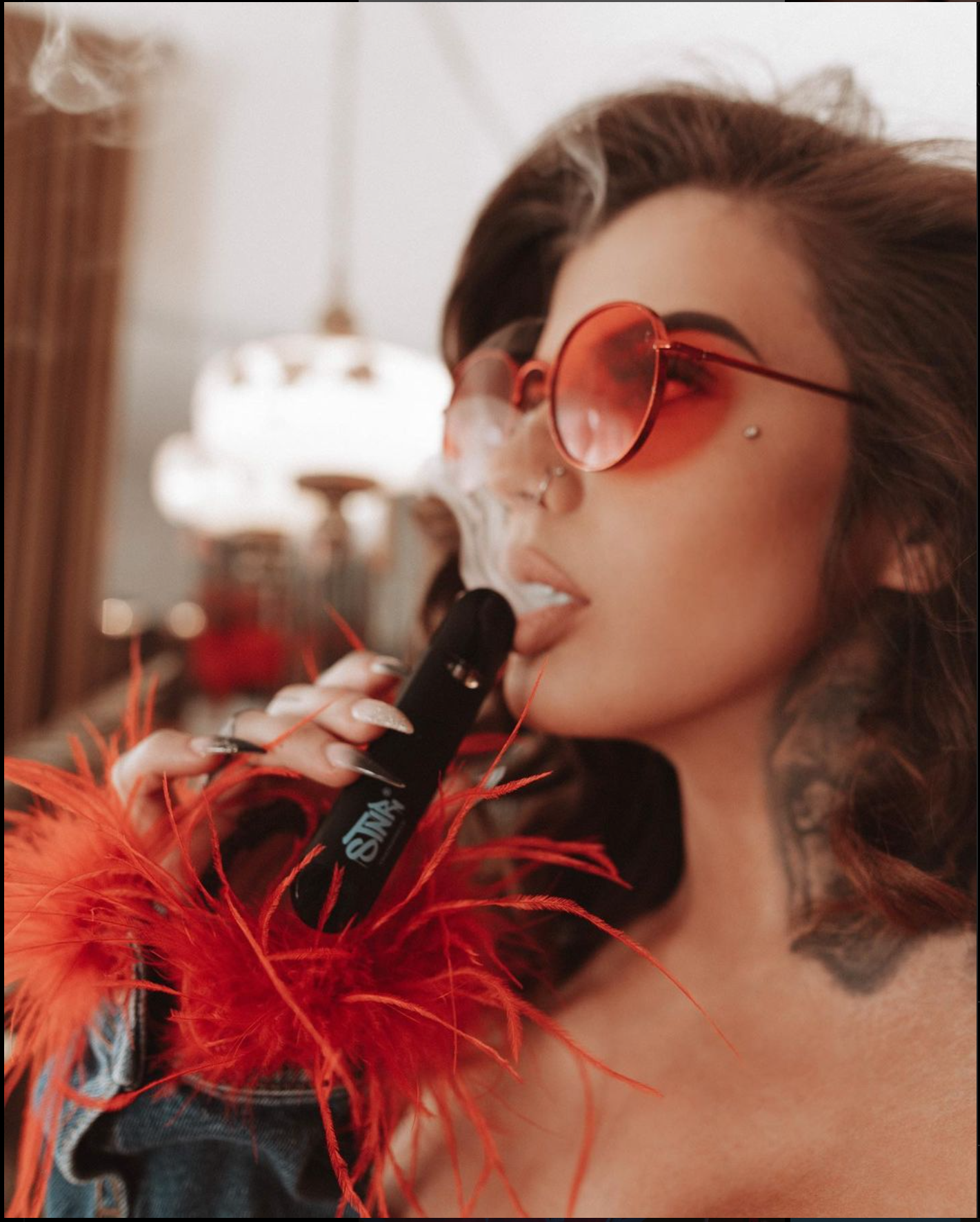 girl enjoying her THC-p vape pen and puffing a huge cloud