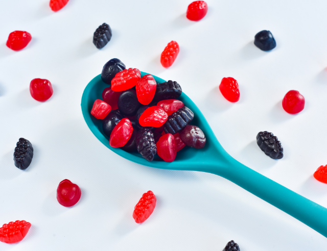 Spoonful of gummies showing the best amanita mushroom gummies.