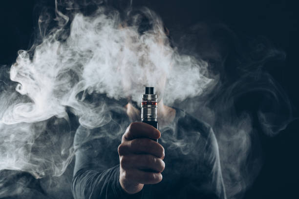 Sub ohm quality shown by an image showing man using vape and blowing smoke.