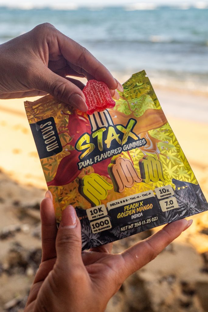 Modus Stax Dual Flavor Gummies displayed on a grassy green background.