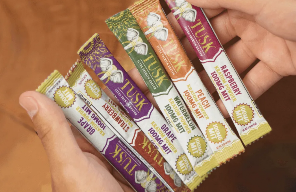 Best Kratom Extract Powder Packets displayed in front of a colorful background.