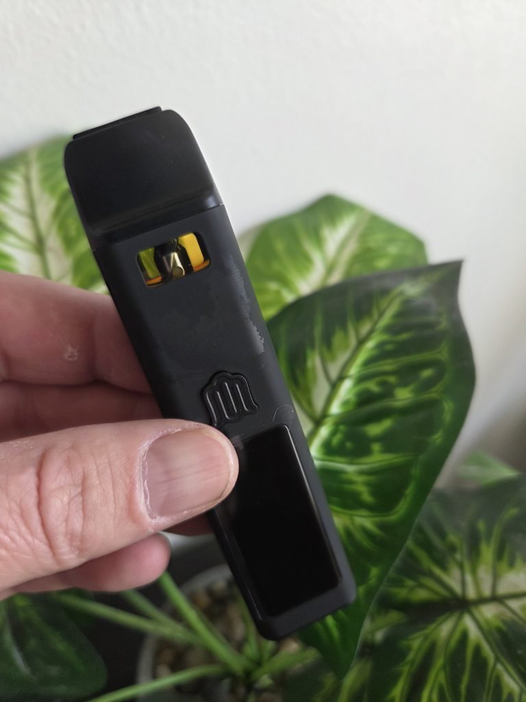 Modus Brand Black Pocket Dabs black device displayed and being held.