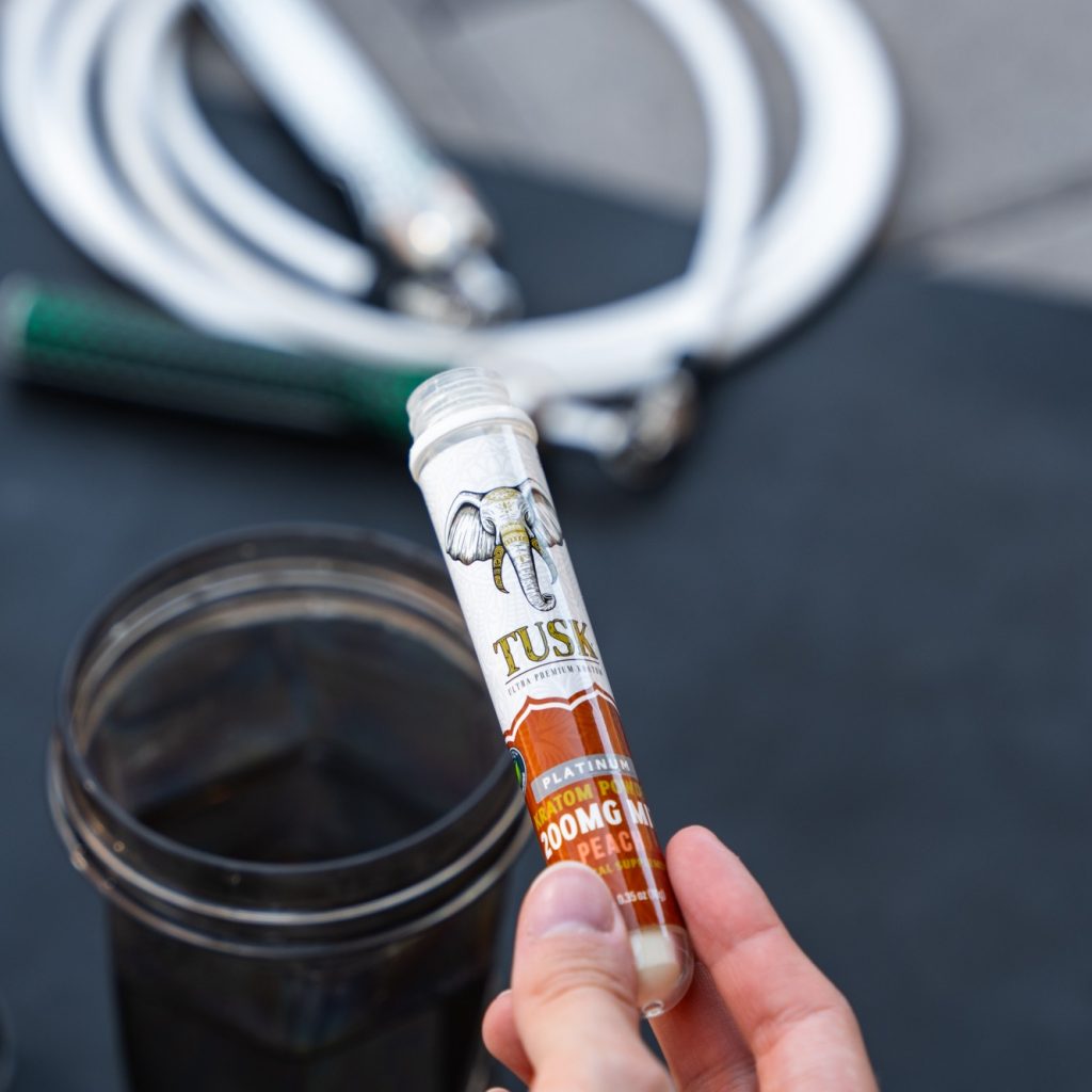 Powder kratom extract displayed in front of a colorful background.