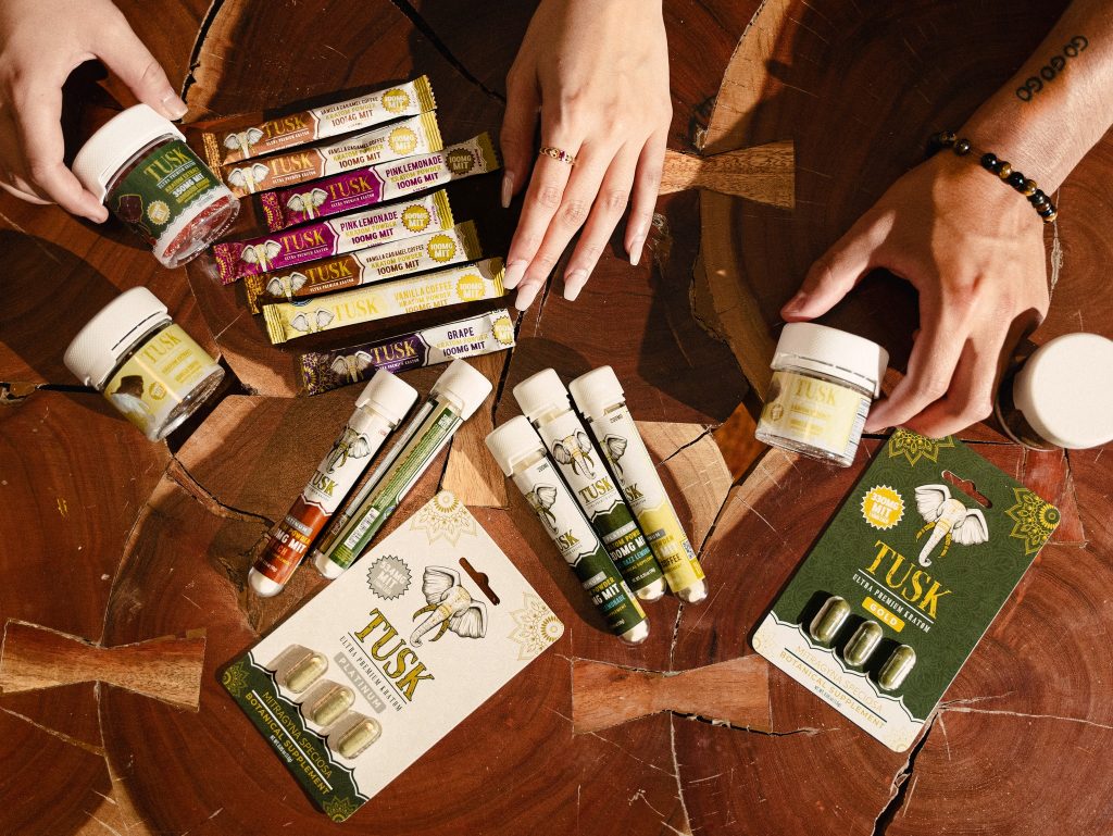 Kratom extract powder tips displayed in front of a beautiful background.