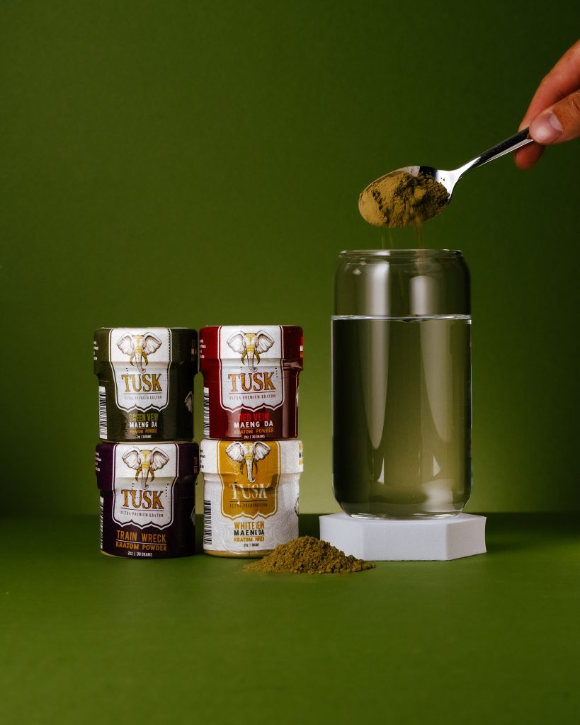 Powder kratom extract displayed in front of a colorful background.