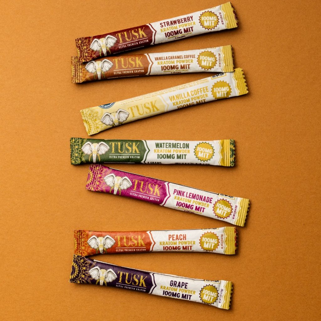 Kratom extract powder tips displayed in front of a beautiful background.