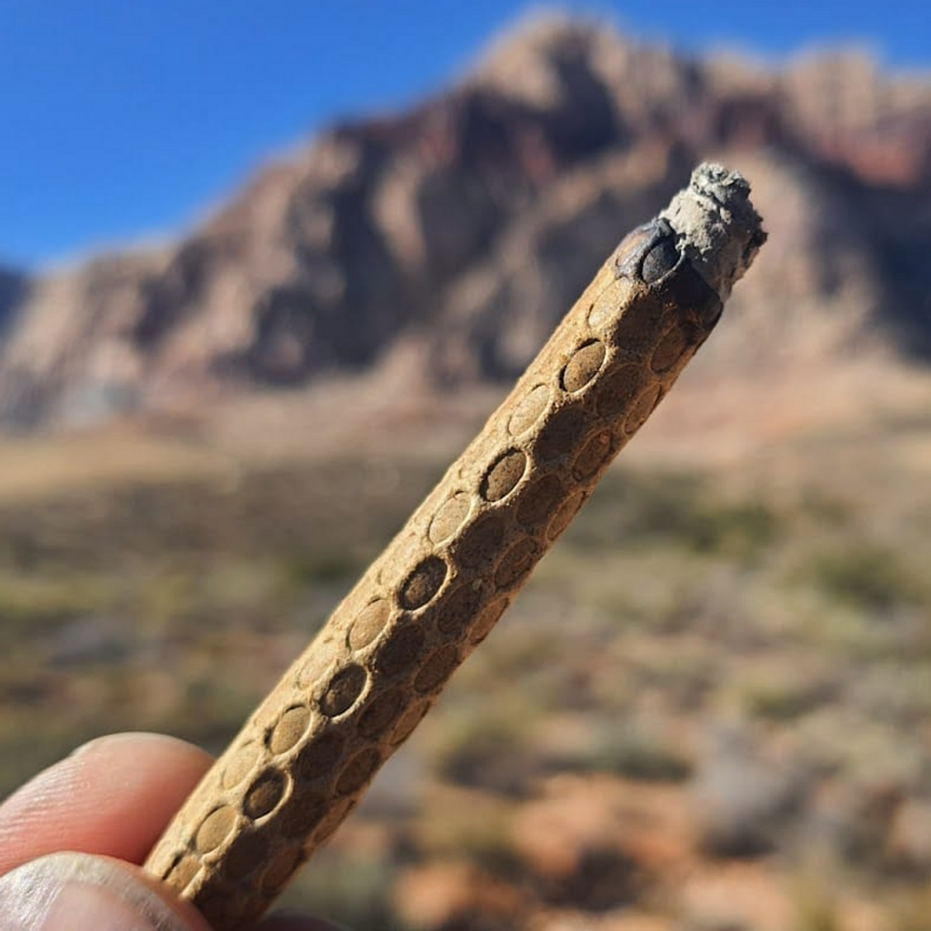 Hemp rolling paper shown on top of a wooden background.