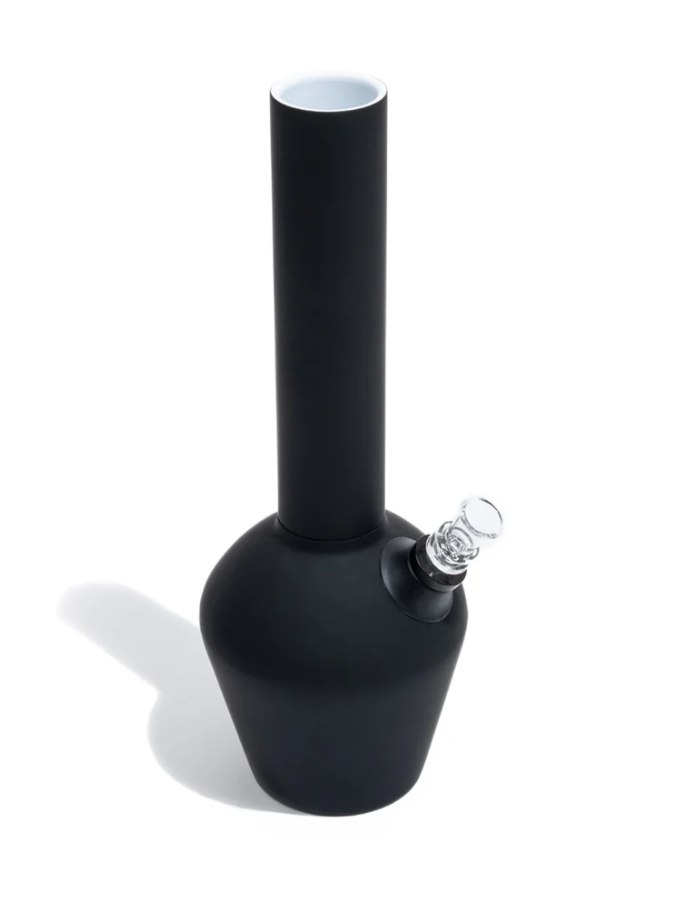 A durable bong for smokers displayed in front of a white background with its shadow shown behind.