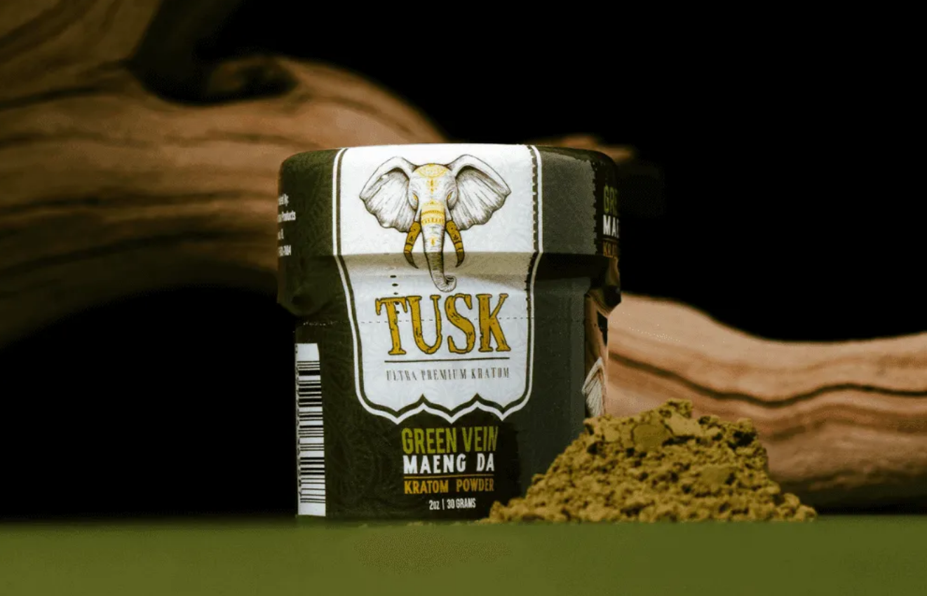 Kratom Capsules vs Kratom Liquid Shots shown in front of a green darkish background.