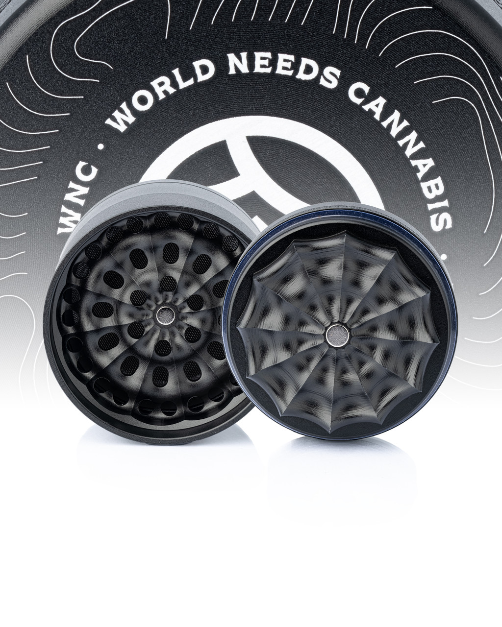 WNC Toothless Grinder displayed in front of the World Needs Cannabis logo showing the interior of the top and bottom parts.