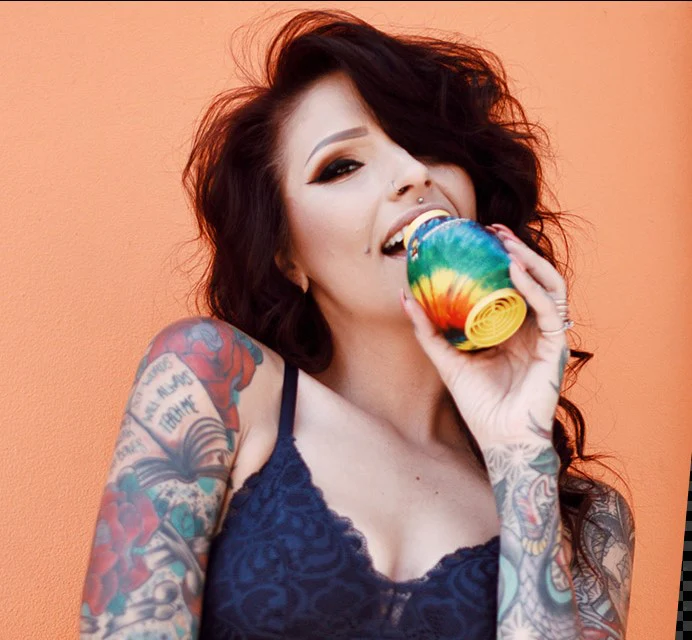 Woman holding one of Smokebuddy's air filters for smoke with a black shirt and black device.