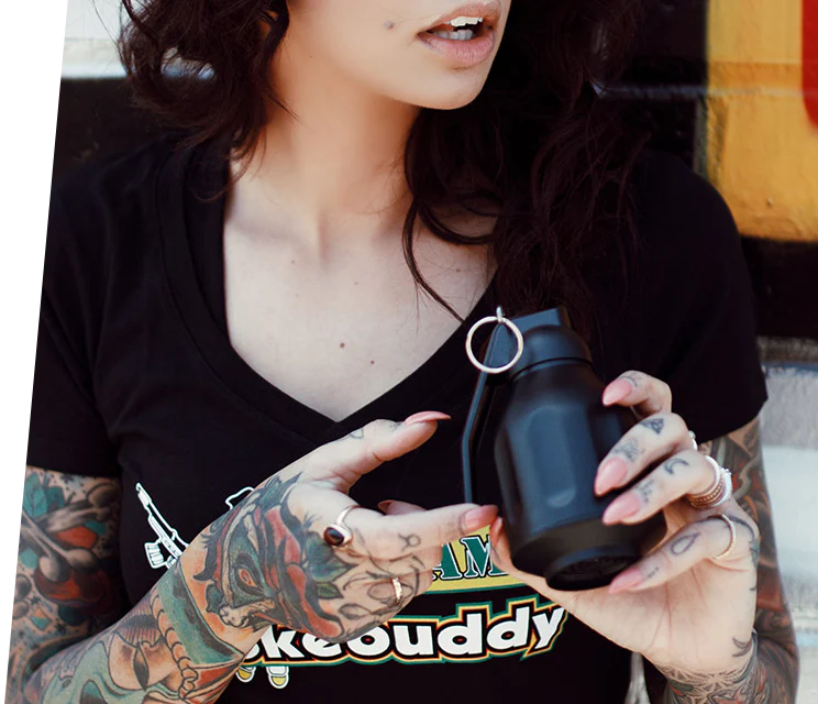 Woman holding one of Smokebuddy's air filters for smoke with a black shirt and black device.