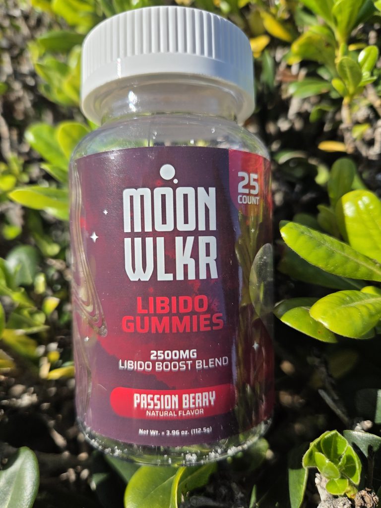 MOONWLKR Delta 9 Libido Gummies - Passion Berry displayed on top of a green patch under the sunlight.