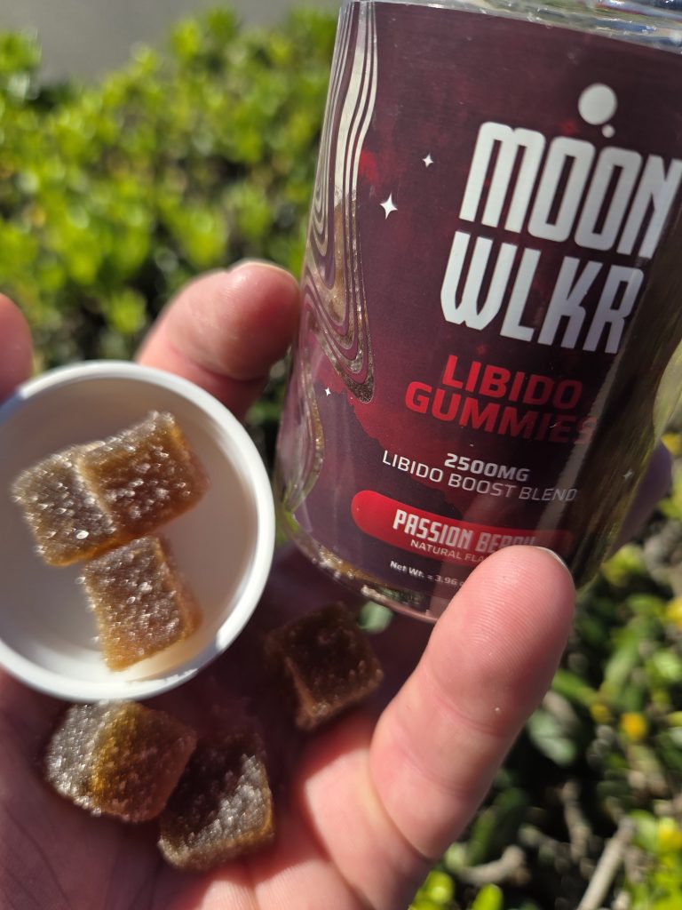 MOONWLKR Delta 9 Libido Gummies - Passion Berry displayed on a cap with the container bottle held by someone.