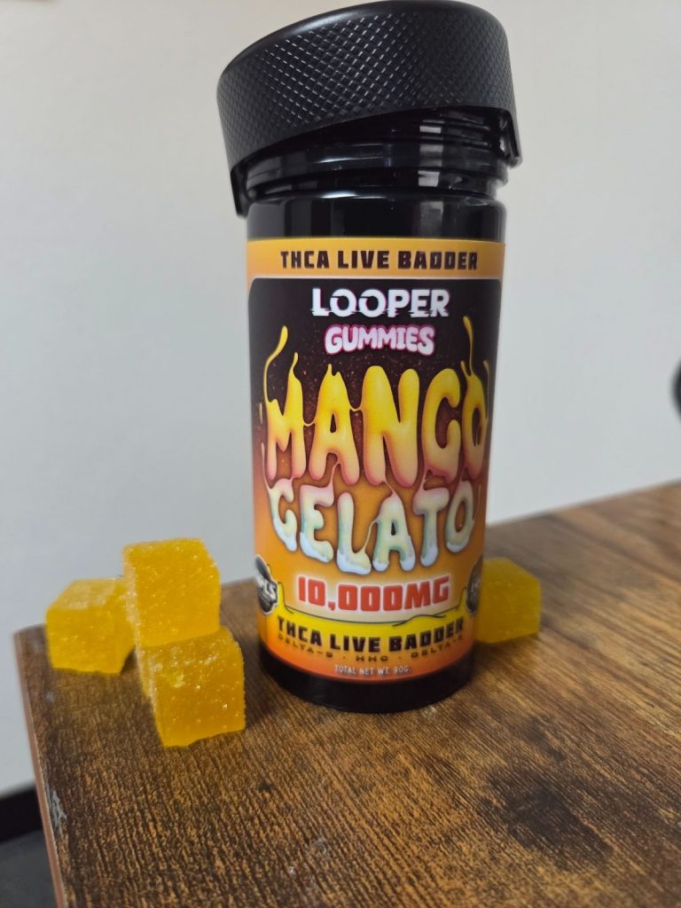 Mango Gelato Gummies displayed on top of a wooden table beside the Looper packaging.