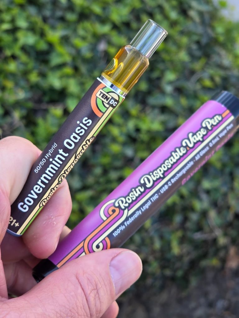 10DC Governmint Oasis products displayed in front of a background near a bush held by someone.