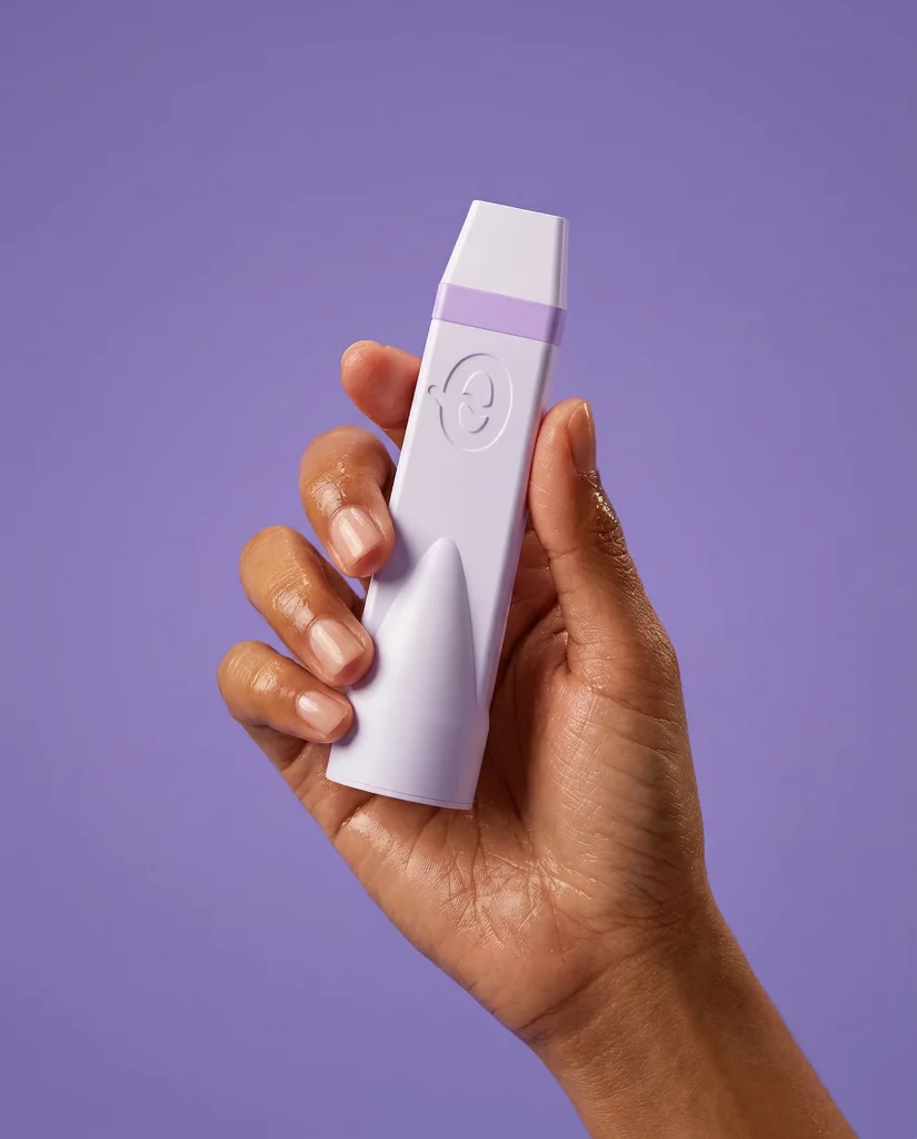 Purple and white CAPNOS product showing how to buy pressurized air inhaler devices, held by someone with a purple background.