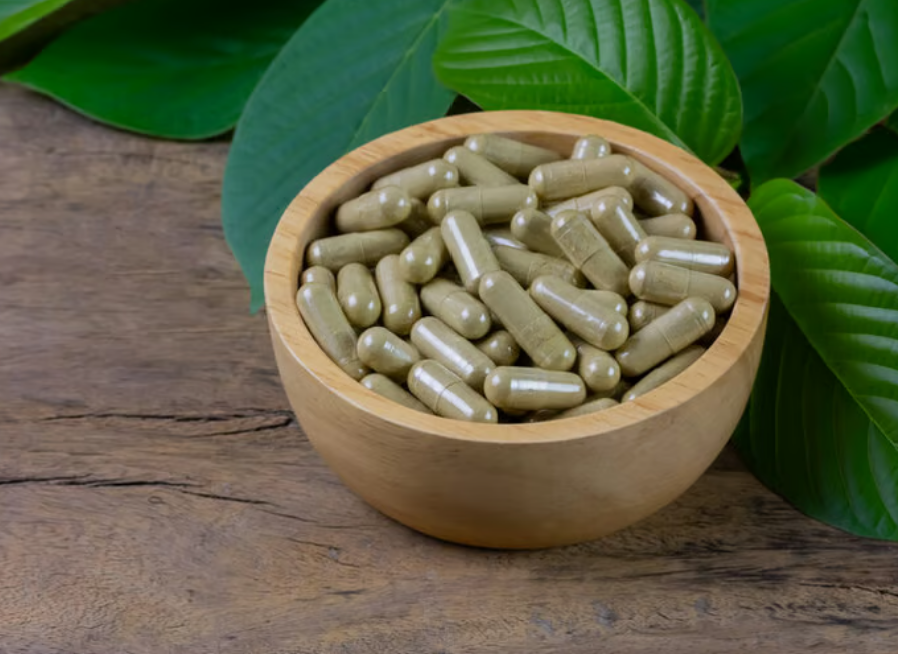 Full Spectrum Kratom Extract product from Tusk Kratom showing the green powder and capsules.