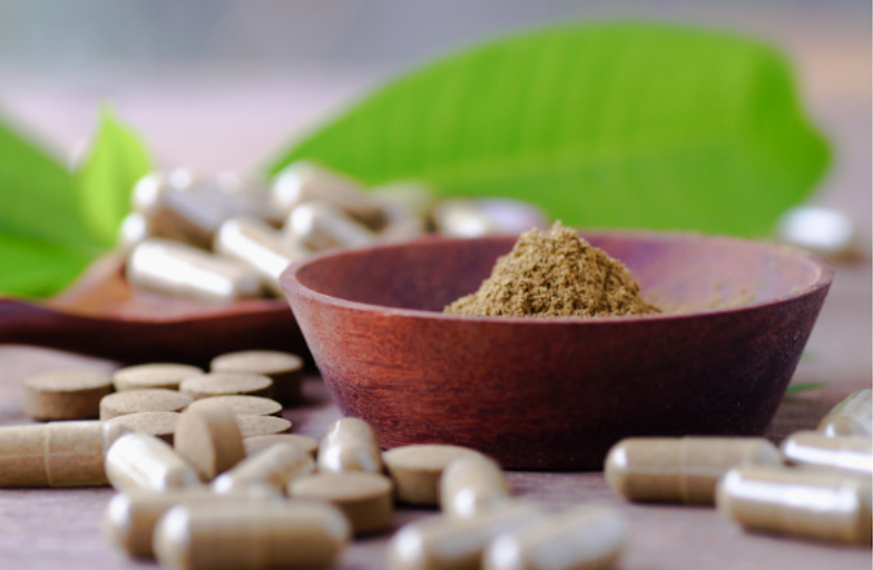 The best kratom capsules 2026 can offer displayed in a bright background inside a room.
