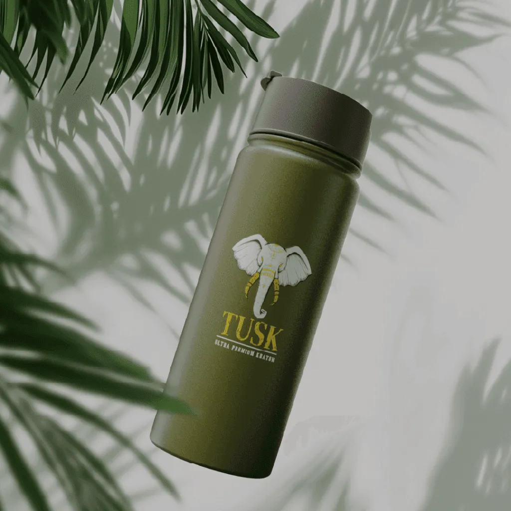 Tusk Kratom tumbler used as an article image for kratom interactions displayed in front of a green and white background with fog and leaves.