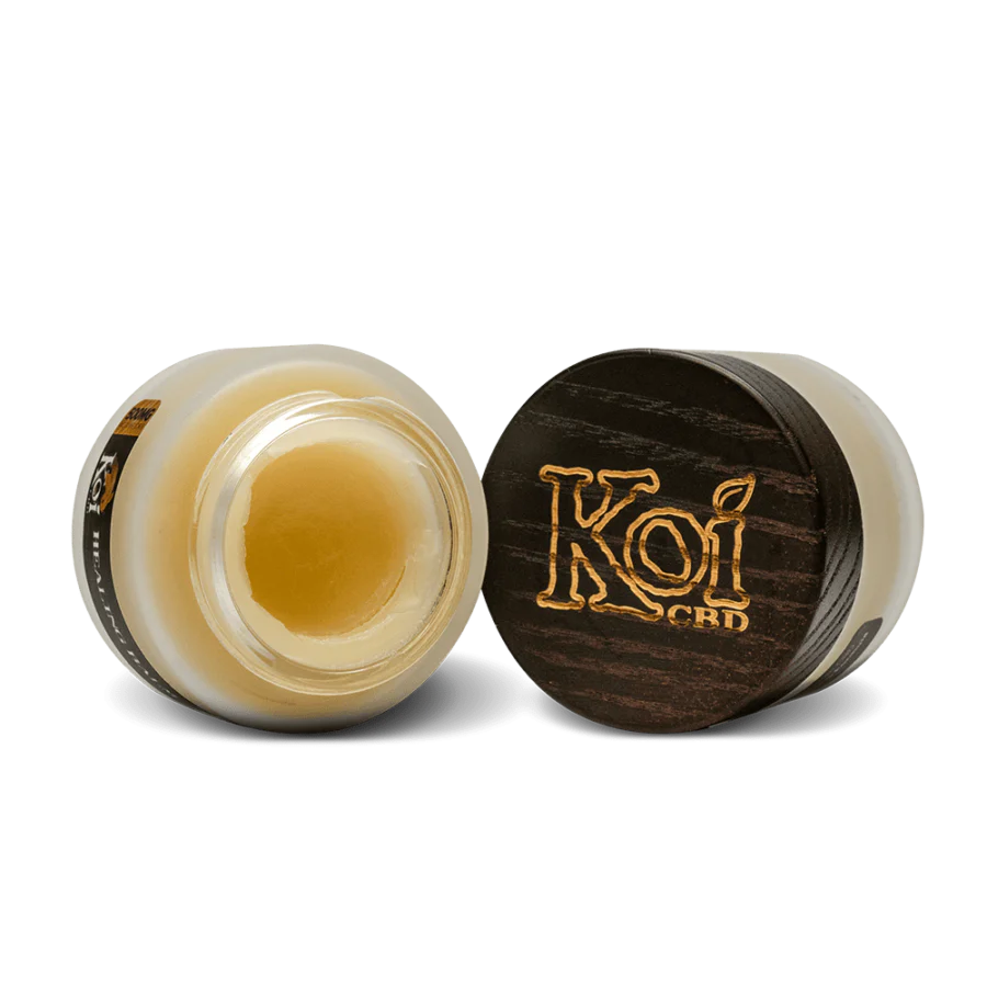 CBD balms from Koi CBD displayed open and sideways in front of a white background showing the text Koi CBD.
