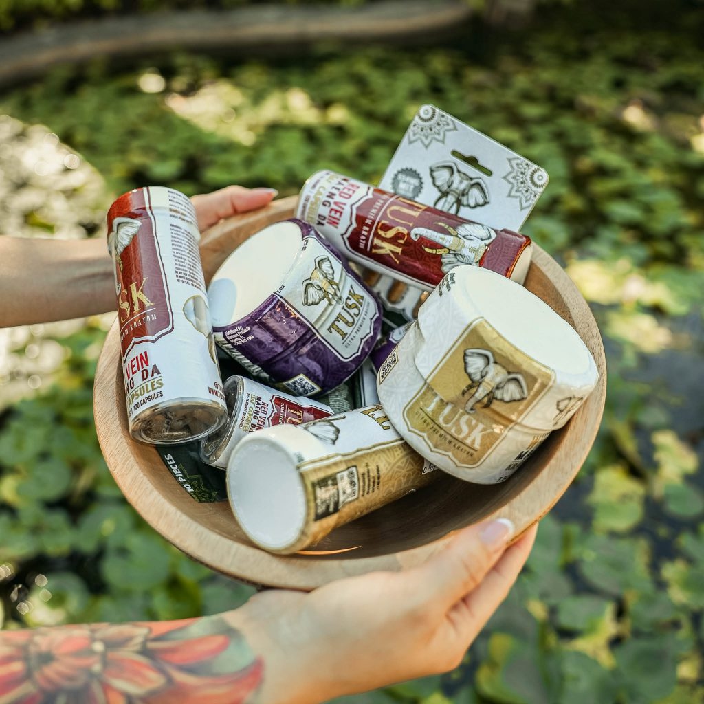 Kratom for sleep products placed on top of a basket resting on a grass.