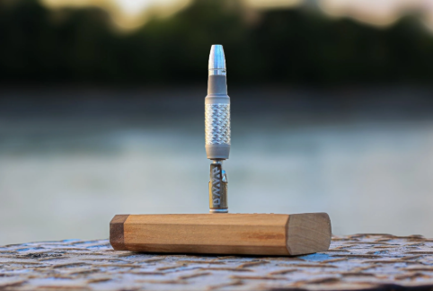 Vaporizer for Dry Herbs displayed in front of an outdoor background overlooking a lake.