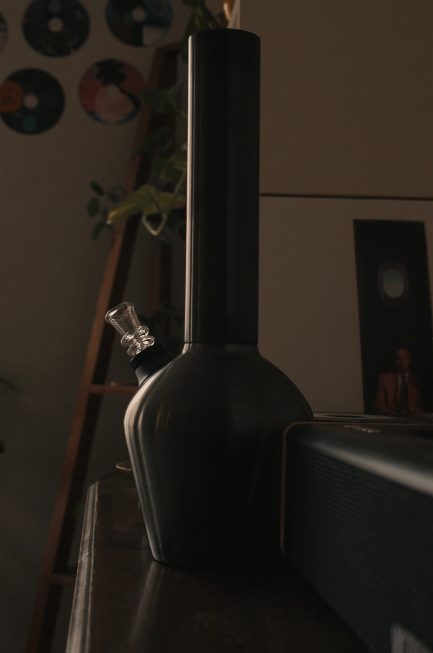 Best bong for a house party displayed in a dark background on top of a wooden cabinet.