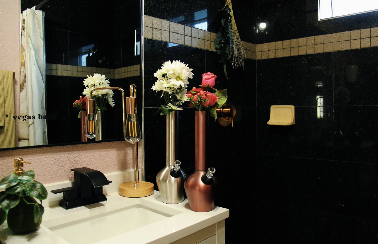 Aesthetic bong by Chill Steel Pipes displayed inside an aesthetic bathroom on a sink with flowers and roses.