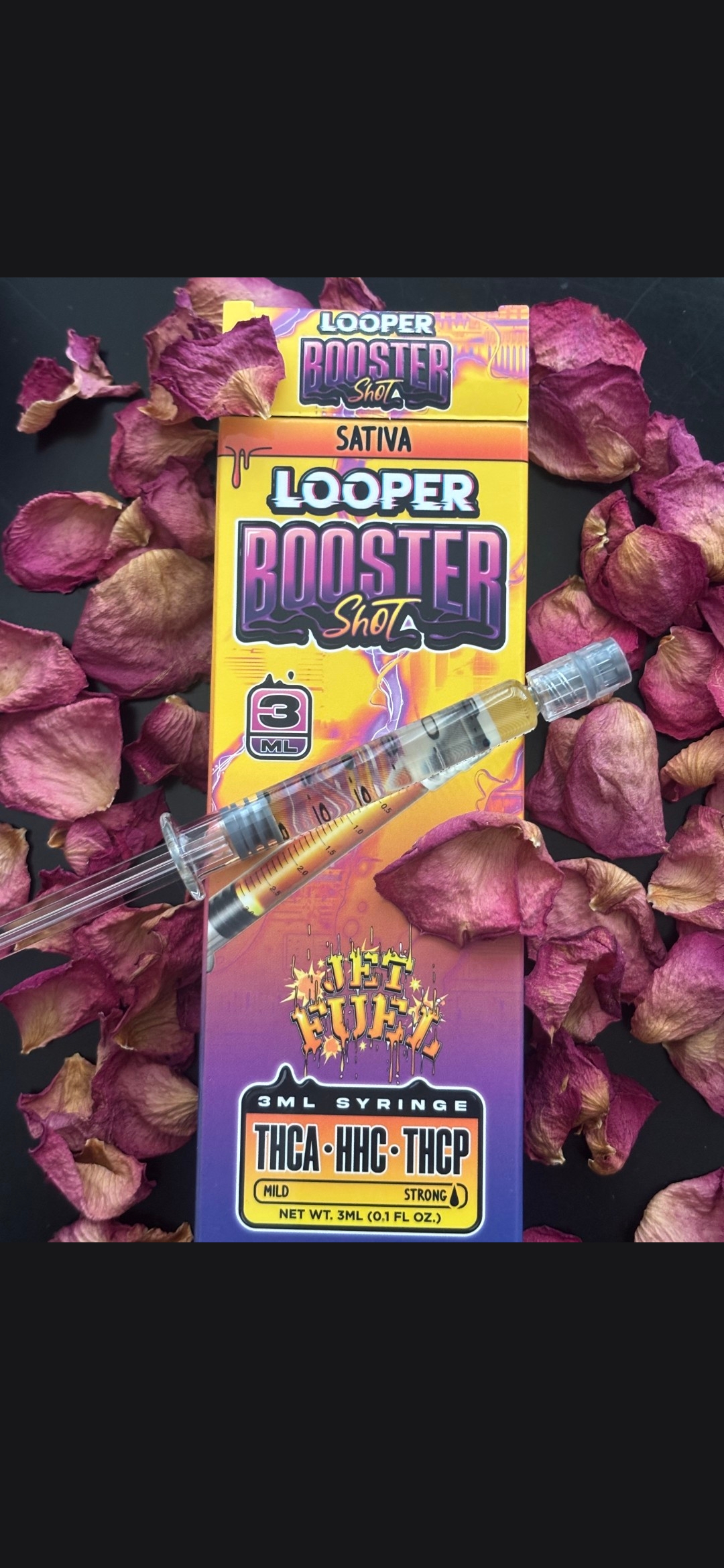 Looper Booster Shot 3ML: Jet Fuel displayed in front of a background of rose petals showing the syringe on top of the box.